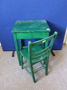 A green painted child`s desk having a lift up lid together with a matching chair, approx. desk size