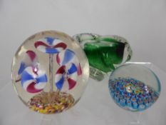 Two Glass Paperweights one in the Milliefiori style and the other in the Caithness style together