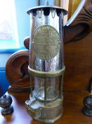 An Eccles Brass Miners Lamp `The Protector Lamp & Lighting Co Ltd, together with a J.H Naylor Ltd