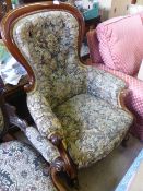 A Large Victorian Spoon Back Armchair, upholstered in floral tapestry fabric.