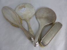 A collection of misc. silver vanity items incl. two mirrors, hairbrush and clothes brush (4)