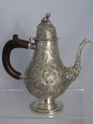 An ornate Italian silver coffee pot having floral decoration to the pot, spout and lid, the lid