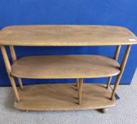 An Ercol style light oak three tier trolley, the shelves being on spindle supports, approx. 92 x 32