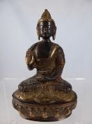 A 19th Century Bronze Buddha seated on a lotus blossom plinth in a contemplative pose, approximate