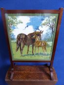 A mahogany fire screen with tapestry depicting a mare and foal, approx. 51 x 26 x 75 cms.