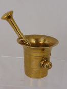 A Vintage Brass Double Handle Pestle and Mortar together with a pair of female torso nut crackers.