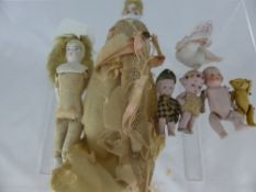 A collection of miscellaneous miniature porcelain dolls together with a miniature articulated teddy