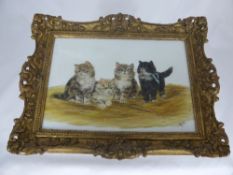 A Hand Painted Porcelain Plaque depicting four kittens on a bed of straw monogrammed BB, in a gilt