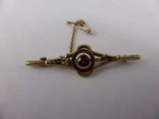 A Lady`s 9ct Gold and Garnet Pin Brooch, with safety chain.