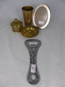 A collection of assorted items including a jumbo size bottle opener, brass beaker, brass lidded