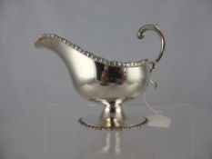 A Solid Silver Sauce Boat, London hallmark, m.m Hasler Brothers, the sauce boat having a rope