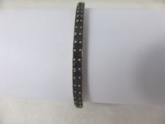 A Lady`s White Metal Garnet Bracelet, the bracelet set with approx fifty stones and a safety chain,