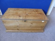 An antique pine blanket box fitted with two small drawers to the interior and having a brass key