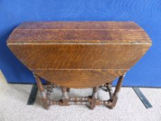 A small oak drop leaf table, gate legged, approx. 66 x 85 x 64 cms.