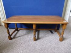 Light Oak Ercol Coffee Table, semi turned supports with rectangular stretches, 115 x 48 x 42 cms.