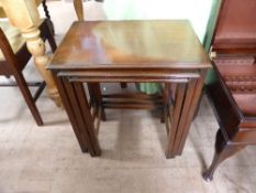 A nest of three oak tables having shaped edges, approx. size of large table 51 x 35 x 56 cms.