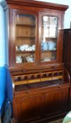 A Victorian Mahogany Roll Top Bureau Bookcase, featuring four shelves to top an the interior fitted