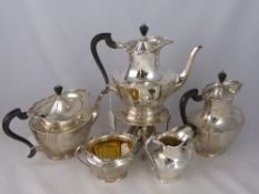 A solid silver London hallmarked tea and coffee set comprising spirit kettle stand, hot water jug,