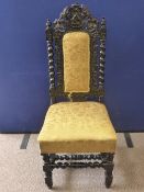 An Antique Stained Oak Hall Chair, the chair ornately carved with vine leaf and grapes, the