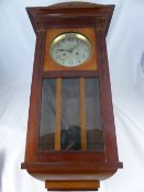 Continental Mahogany Wall Clock, brass face, with black dial, approx 88 x 32 cms.