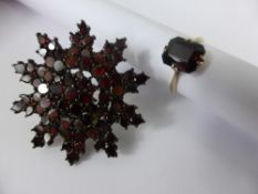 A Lady`s Vintage Garnet Brooch, in the form of a snowflake together with a lady`s 9ct gold garnet