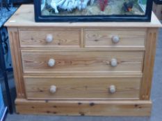 A pine chest of drawers on a plinth base with two short and two long drawers, approx. 108 x 52 x 78