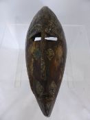 A Dogon Mali Tribal face masks having a metal face plate, approx. 35 cms. in length