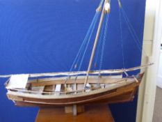 A Model Replica of a Zanzibar Dhow, supported on a fitted stand. 120 cms x 100 x 33 cms, the model
