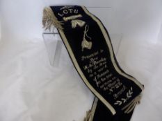 Blue velvet and silver thread work sash, the sash presented to `Bros H A Burley Chair of the 23rd