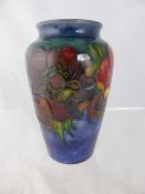 A Moorcroft Vase depicting Poppies, factory stamped to base 13 cms in height.