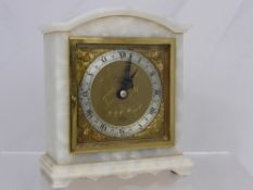 A white marble mantle clock by A S Elliott, the face inscribed John Crouch Ltd., approx. 16 x 14 x
