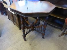 A Victorian octagonal mahogany occasional table having turned legs with cross stretcher supports