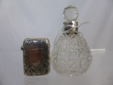 A Silver Birmingham Hallmark Vesta Case together with a cut glass perfume bottle.