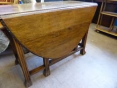 An Oak Gate-Leg Drop Leaf Table with ""pie crust"" edging, 104 cms x 145 cms x 72 cms high on