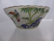 An Antique Chinese Bowl and Saucer, the bowl having butterfly and flowers design with matching