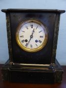 A Victorian slate mantle clock by Thomas Gwynne, 1839 - 1855, with an enamel face.