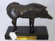 A Bronze Figure of a Wild Boar supported on a wooden plinth with a brass plaque which reads ""In