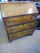 An antique mahogany bureau having three drawers on bracket feet, the interior being fitted with