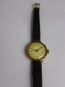 9 ct Gold Watch, on a brown leather strap.