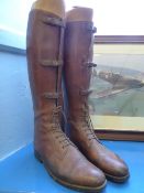 A pair of vintage leather strap front riding boots, possibly cavalry, with lasts.