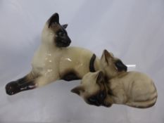 A Beswick figure of a Siamese cat (1338) together with a study of kittens (1296)