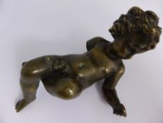 A bronze figure of a cherub, signed B M to the arm, believed to be part of a clock, approx. 16 cms
