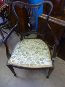 A Victorian mahogany elbow chair having tapered legs and spade feet to the front, splat back with