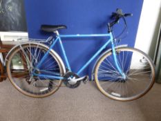 A gent`s blue Raleigh Pioneer Prestige bicycle, having twelve gears.