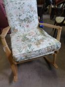 A light wood vintage Parker Knoll rocking chair being covered in floral patterned fabric.