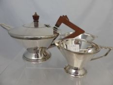 A Silver Plate Art Deco Tea Trio comprising Tea Pot, Milk Jug and Sugar Bowl.