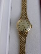 9 ct Gold Lady`s Automatic Omega Wrist Watch, the watch having a gold face with baton numerals,