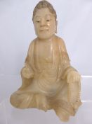 An antique Chinese carved polished soapstone / jade figure of a seated Buddha, the figure having