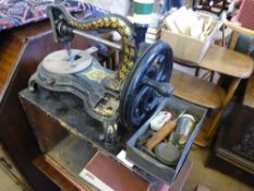 A small vintage Jones sewing machine in a wooden case.