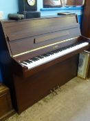 An upright Kemble Piano, K Classic II, in a mahogany case.